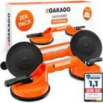Zwei orange Saugheber mit schwarzen Saugtellern vor der Verpackung des Zweierpacks