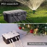 Box im Rasen neben einem laufenden Rasensprenger