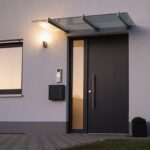 Moderne Haustür in der Abenddämmerung mit Hikvision Türsprechanlage neben dem Eingang